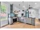 Bright kitchen boasts stainless steel appliances, farmhouse sink, and hardwood floors at 767 Fletcher Ave, Indianapolis, IN 46203