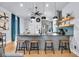 Modern kitchen with stainless steel appliances, island seating, and hardwood floors at 767 Fletcher Ave, Indianapolis, IN 46203
