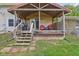 Cozy covered back porch with wood construction, grill, and furniture at 775 Baker Rd, Martinsville, IN 46151