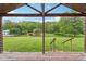 Beautiful backyard view from the covered back porch showing mature trees and greenery at 775 Baker Rd, Martinsville, IN 46151