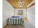 This bedroom features a wood ceiling, carpeted floor, and natural wood trim at 775 Baker Rd, Martinsville, IN 46151