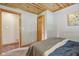 This bedroom features a wooden ceiling, carpeted floor, and natural wood trim at 775 Baker Rd, Martinsville, IN 46151