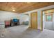 The carpeted bonus room offers a mini fridge, work space, and cozy bedroom alcove at 775 Baker Rd, Martinsville, IN 46151