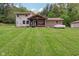 This home is complete with a covered patio and metal roof offering serene outdoor living and a stone-accented exterior at 775 Baker Rd, Martinsville, IN 46151