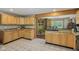 Spacious kitchen with light wood cabinets, tile flooring, and an open layout to the living area at 775 Baker Rd, Martinsville, IN 46151