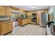 Well-lit kitchen featuring stainless steel appliances, wood cabinets, and tile flooring at 775 Baker Rd, Martinsville, IN 46151