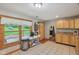 Cozy kitchen with wooden cabinets, tile floors, and a window overlooking a serene landscape at 775 Baker Rd, Martinsville, IN 46151