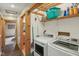 This is a laundry room with a washer, dryer, utility sink, and storage shelves at 775 Baker Rd, Martinsville, IN 46151