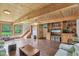 Inviting living room featuring wood-paneled ceiling, hardwood floors, and custom built-in shelving at 775 Baker Rd, Martinsville, IN 46151