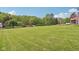 Expansive green lawn leads up to a charming home, with mature trees, all under a beautiful, open sky at 775 Baker Rd, Martinsville, IN 46151