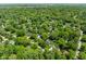 Expansive aerial view of lush neighborhood with mature trees and glimpses of residences at 7843 Windcombe Blvd, Indianapolis, IN 46240