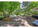 Spacious backyard patio area surrounded by mature trees and lush landscaping at 7843 Windcombe Blvd, Indianapolis, IN 46240