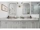 Modern bathroom featuring a double vanity, marble countertops, and decorative mirrors at 7843 Windcombe Blvd, Indianapolis, IN 46240