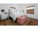 Comfortable primary bedroom with white linens, blue headboard and hardwood floors at 7843 Windcombe Blvd, Indianapolis, IN 46240