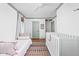 Bright bedroom showcasing neutral wall paint, hardwood flooring and a crib at 7843 Windcombe Blvd, Indianapolis, IN 46240