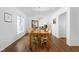 Elegant dining room features a chandelier, wood table, and ample natural light at 7843 Windcombe Blvd, Indianapolis, IN 46240