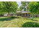 Attractive brick home with well-maintained lawn, mature trees, and a classic, inviting facade at 7843 Windcombe Blvd, Indianapolis, IN 46240