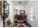 Inviting foyer with wood furniture, stylish decor, and a decorative rug on a black tiled floor at 7843 Windcombe Blvd, Indianapolis, IN 46240