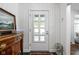 Hallway featuring a white door, side table, artwork and an umbrella stand at 7843 Windcombe Blvd, Indianapolis, IN 46240