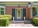 Classic red brick home entrance with decorative planters, black shutters, and clear house number at 7843 Windcombe Blvd, Indianapolis, IN 46240