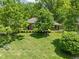 Well-manicured front yard with green lawn, mature trees, and neatly trimmed hedges at 7843 Windcombe Blvd, Indianapolis, IN 46240