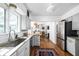 Open kitchen with stainless steel appliances, a large sink, and a view to the living spaces at 7843 Windcombe Blvd, Indianapolis, IN 46240