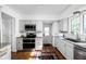 Modern kitchen with stainless steel appliances, subway tile, and granite countertops at 7843 Windcombe Blvd, Indianapolis, IN 46240