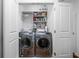 Functional laundry area with modern washer and dryer, and organized shelving at 7843 Windcombe Blvd, Indianapolis, IN 46240