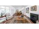 Bright living room with hardwood floors, fireplace, and an open floor plan to the dining area at 7843 Windcombe Blvd, Indianapolis, IN 46240