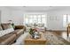 Cozy living room with large bay window, comfortable seating, and stylish area rug at 7843 Windcombe Blvd, Indianapolis, IN 46240
