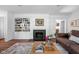 Cozy living room with a fireplace, built-in bookshelves, and a comfortable leather couch at 7843 Windcombe Blvd, Indianapolis, IN 46240