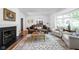 Bright living room featuring a fireplace and comfortable seating, creating an inviting atmosphere at 7843 Windcombe Blvd, Indianapolis, IN 46240