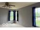 Bedroom featuring blue curtains and a ceiling fan with neutral colored paint at 8002 Windham Lake Way # 33, Indianapolis, IN 46214