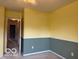 Bedroom featuring neutral carpet and yellow and green accent walls at 8002 Windham Lake Way # 33, Indianapolis, IN 46214