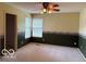 Spacious bedroom with two windows, neutral carpet, and a ceiling fan with integrated lighting at 8002 Windham Lake Way # 33, Indianapolis, IN 46214