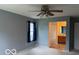 Spacious bedroom featuring a ceiling fan and an attached bathroom with neutral paint at 8002 Windham Lake Way # 33, Indianapolis, IN 46214