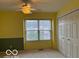 Bedroom featuring neutral carpet, a large window for natural light, and a double-door closet at 8002 Windham Lake Way # 33, Indianapolis, IN 46214