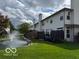 Exterior view of back of townhomes with a fountain in the pond at 8002 Windham Lake Way # 33, Indianapolis, IN 46214