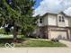 Charming two-story home featuring a well-manicured lawn, attached garage, and beautiful landscaping at 8002 Windham Lake Way # 33, Indianapolis, IN 46214