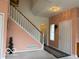 Spacious foyer featuring a staircase with white railings and carpeted steps, and natural light at 8002 Windham Lake Way # 33, Indianapolis, IN 46214