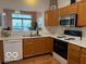 Kitchen with light wood cabinetry and view to a sunlit dining or living space at 8002 Windham Lake Way # 33, Indianapolis, IN 46214