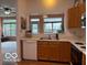 Galley-style kitchen with a pass-through window offering a view of the adjacent living space at 8002 Windham Lake Way # 33, Indianapolis, IN 46214