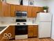 Eat-in kitchen featuring white countertops, stainless steel appliances and wood cabinets at 8002 Windham Lake Way # 33, Indianapolis, IN 46214