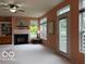 Spacious living room with fireplace, built-in shelving, and backyard access at 8002 Windham Lake Way # 33, Indianapolis, IN 46214