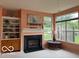 Comfortable living room includes fireplace, built-in shelves, and natural light at 8002 Windham Lake Way # 33, Indianapolis, IN 46214