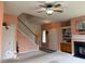 Comfortable living room featuring staircase, neutral walls, and ceiling fan at 8002 Windham Lake Way # 33, Indianapolis, IN 46214