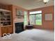 Cozy living room featuring fireplace, built-in shelves, and bright windows at 8002 Windham Lake Way # 33, Indianapolis, IN 46214