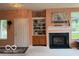 Comfortable living room featuring fireplace, built-in shelving and backyard views at 8002 Windham Lake Way # 33, Indianapolis, IN 46214