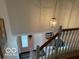 View of the staircase with a hanging light fixture and entryway at 8002 Windham Lake Way # 33, Indianapolis, IN 46214