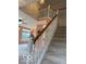 View of the staircase with white banisters and natural wood railing at 8002 Windham Lake Way # 33, Indianapolis, IN 46214